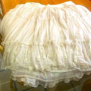 Tutu skirt with little flowers at the bottom it’s a off with color maybe ivory